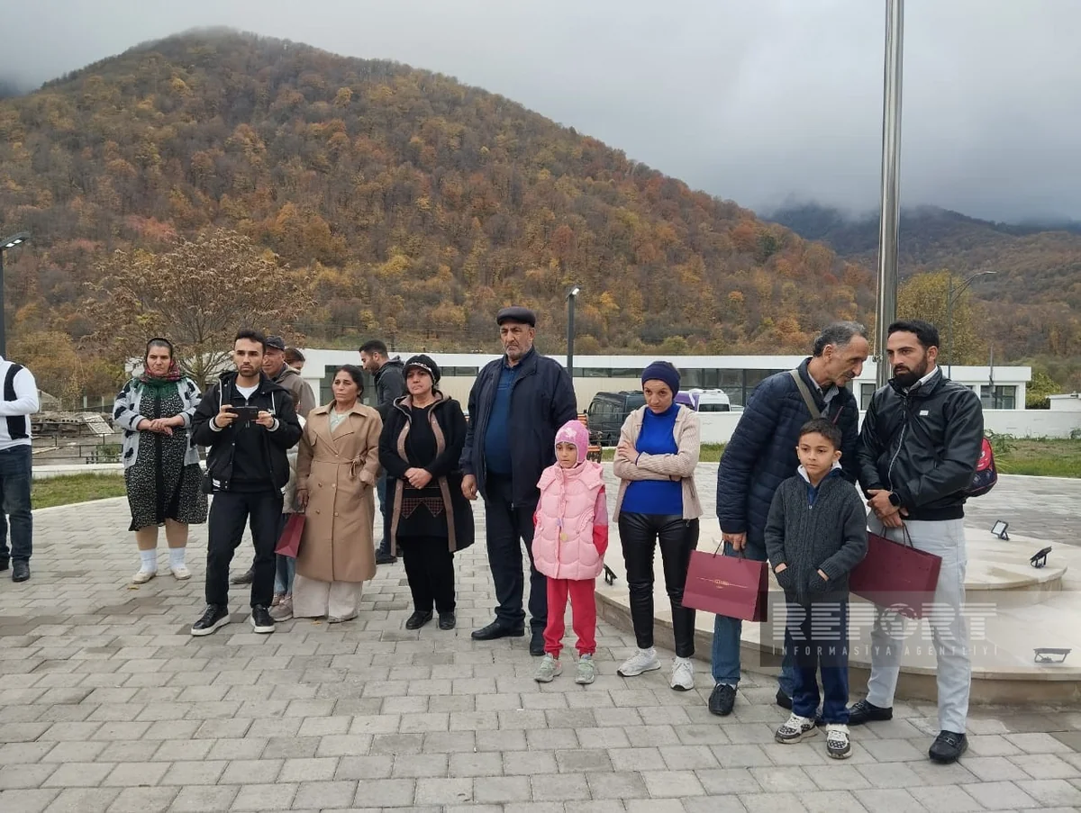 Residents who arrived in Vangli village in Azerbaijan's Agdara district receive keys