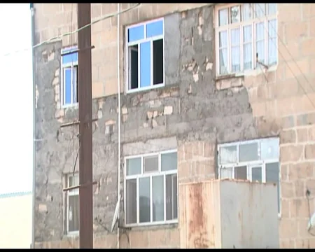 Göyçayın mərkəzində binanın fasadının daşları yerə tökülür: sakinlər təhlükə ilə üzləşib
