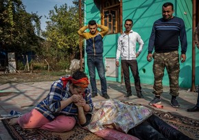 TIME's top photos of 2020: Sister Kisses hand of martyred brother