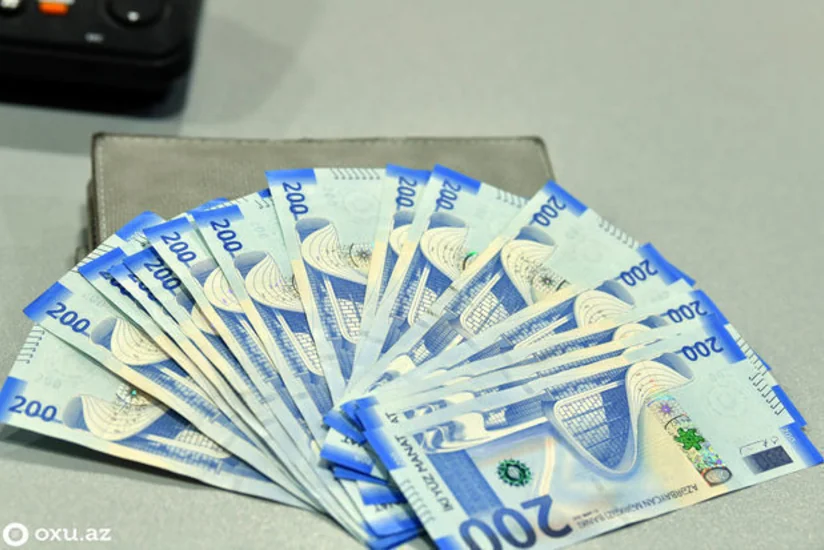 What led to reduction of pressure on Azerbaijan's national currency?