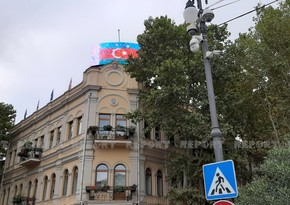 Azerbaijani flag displayed on monitors in Tbilisi