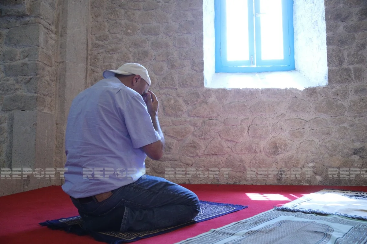 Media representatives of Turkic Council member and observer states perform prayers at Yukhari Govhar Agha Mosque