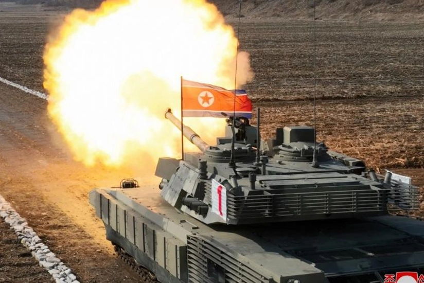 North Korea's Kim 'drives' new tank during mock battle