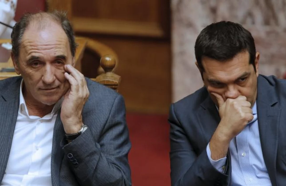 Greek PM Tsipras wins bailout vote, faces widening rebellion
