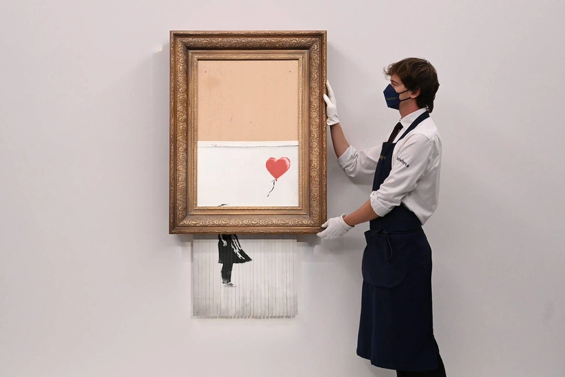 Banksy’s shredding artwork auctioned for $25.4M