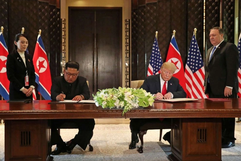 Trump and Kim Jong-UN signes document following results of meeting in Singapore