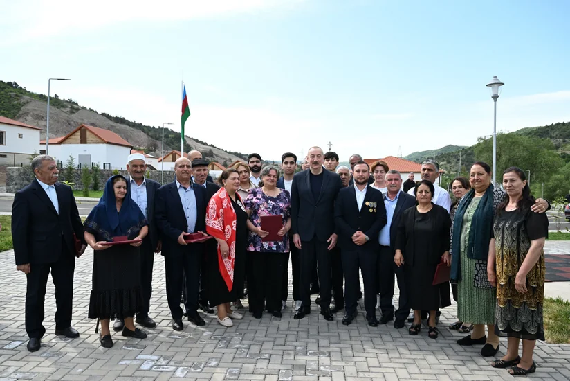 President Ilham Aliyev meets with residents relocated to Beylik village in Lachin, presents keys to new homes