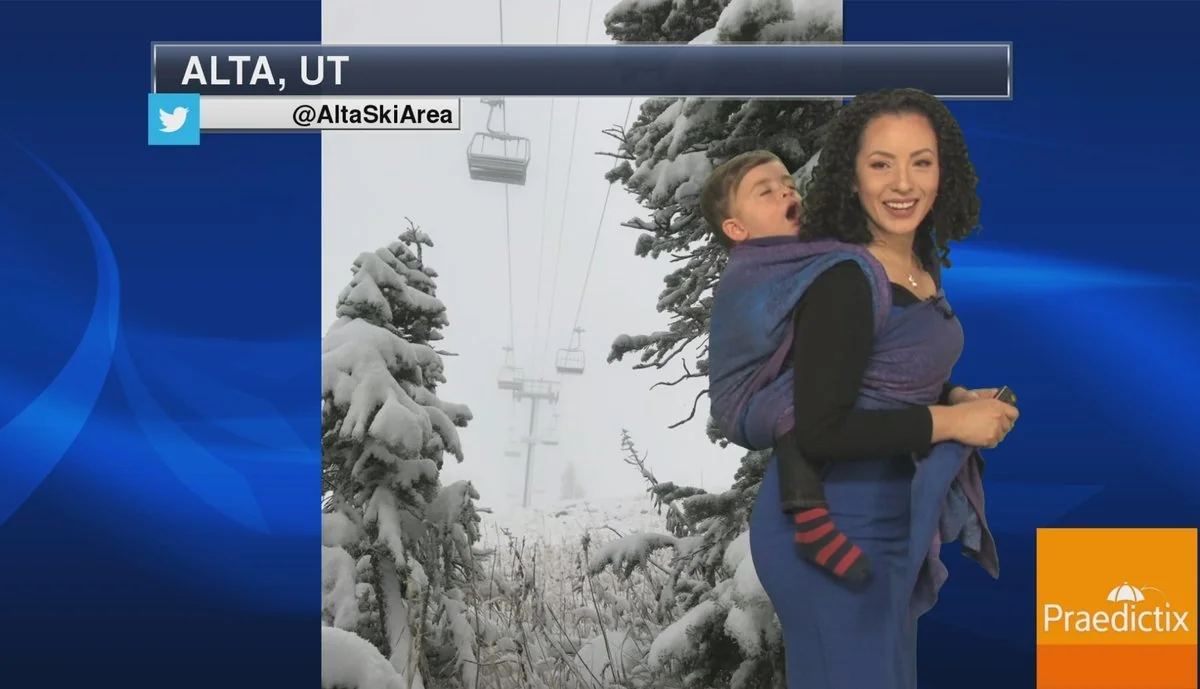 Meteorologist appears on air carrying young son on her back in US - VIDEO