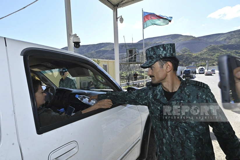Azerbaijani border guards distribute water and sweets to Armenian residents of Karabakh