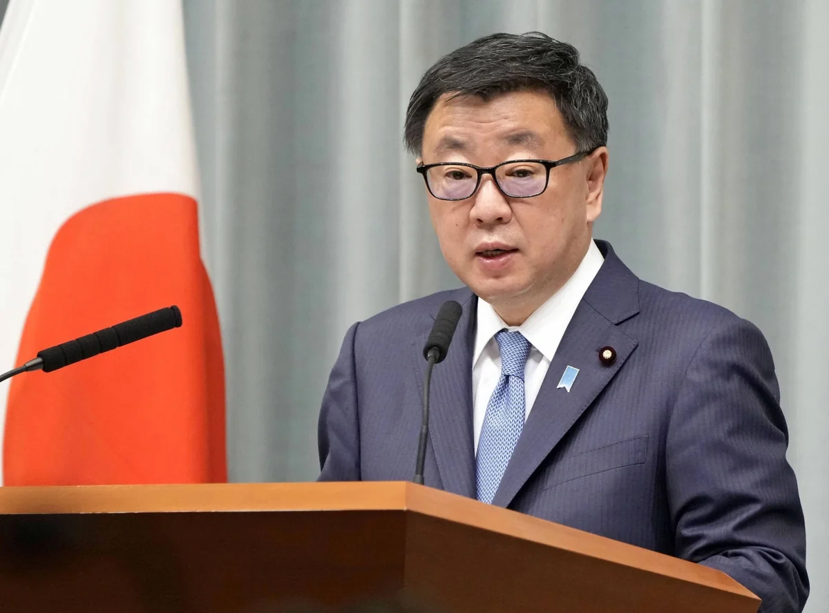 Japan's ex-top spokesman questioned in finance probe