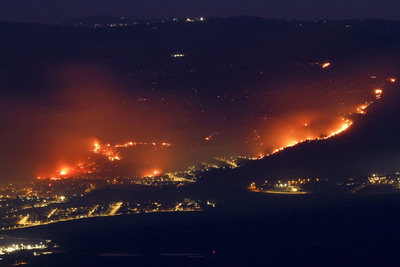Fires rage in northern Israel after rocket attacks; key roads closed off