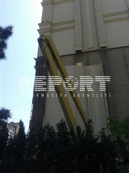 Yanan binanın ətrafındakı binaların üzlükləri sökülür