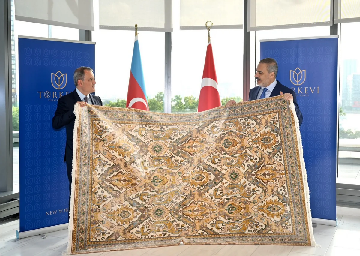 Jeyhun Bayramov presents Hakan Fidan with Karabakh carpet