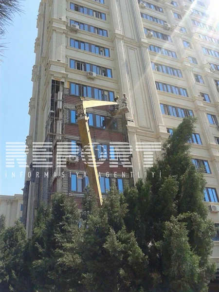 Yanan binanın ətrafındakı binaların üzlükləri sökülür