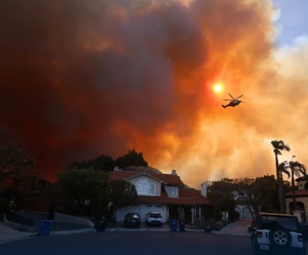 Wildfire tears through affluent suburbs of north Los Angeles
