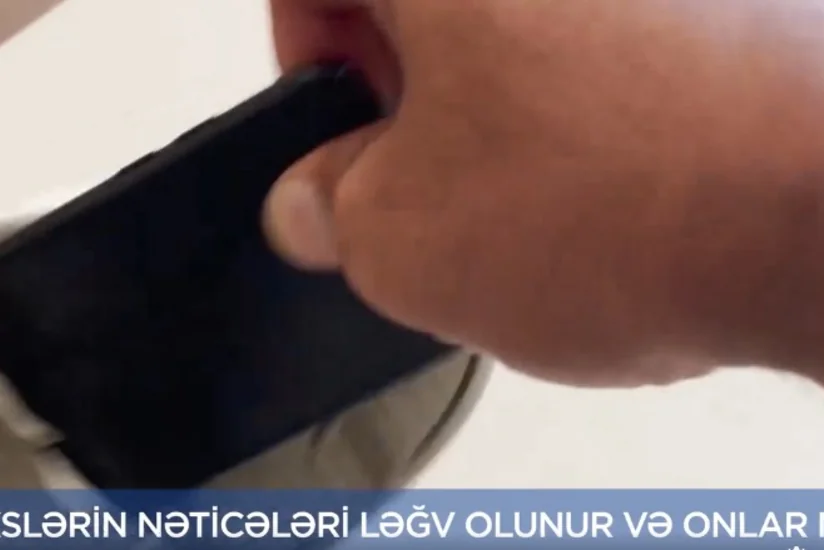 DİM: İmtahan iştirakçısı mobil telefonunu ayaqqabısının altında gizlətməyə cəhd göstərib